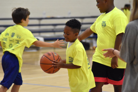 Children playing basketball at Benson gym