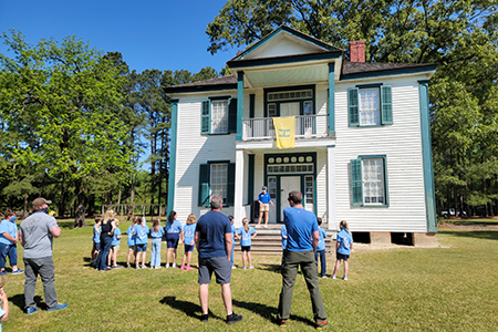 Field trip group taking a tour of the Harper House; view outside front door