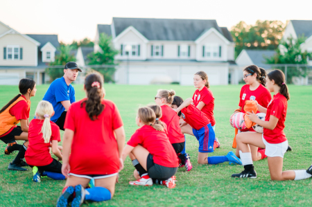 A coach talking to his team during practice