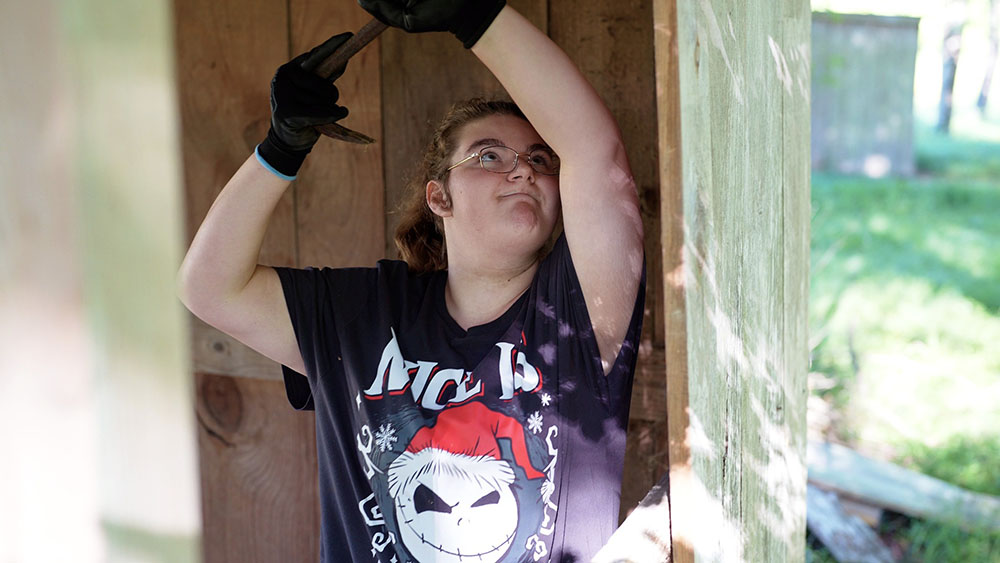 A student hard at work with a crowbar