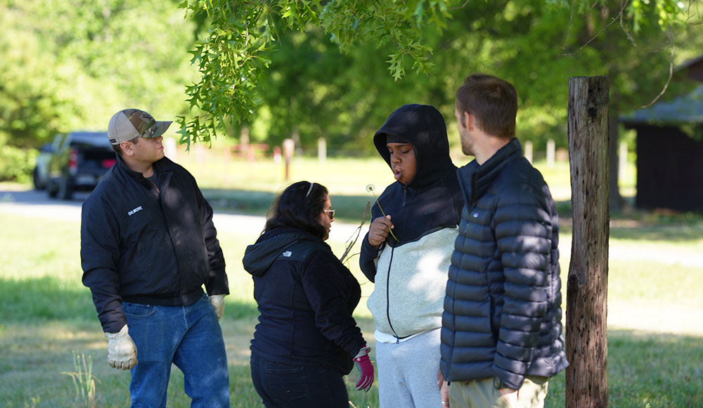Students and specialists taking a break in the shade